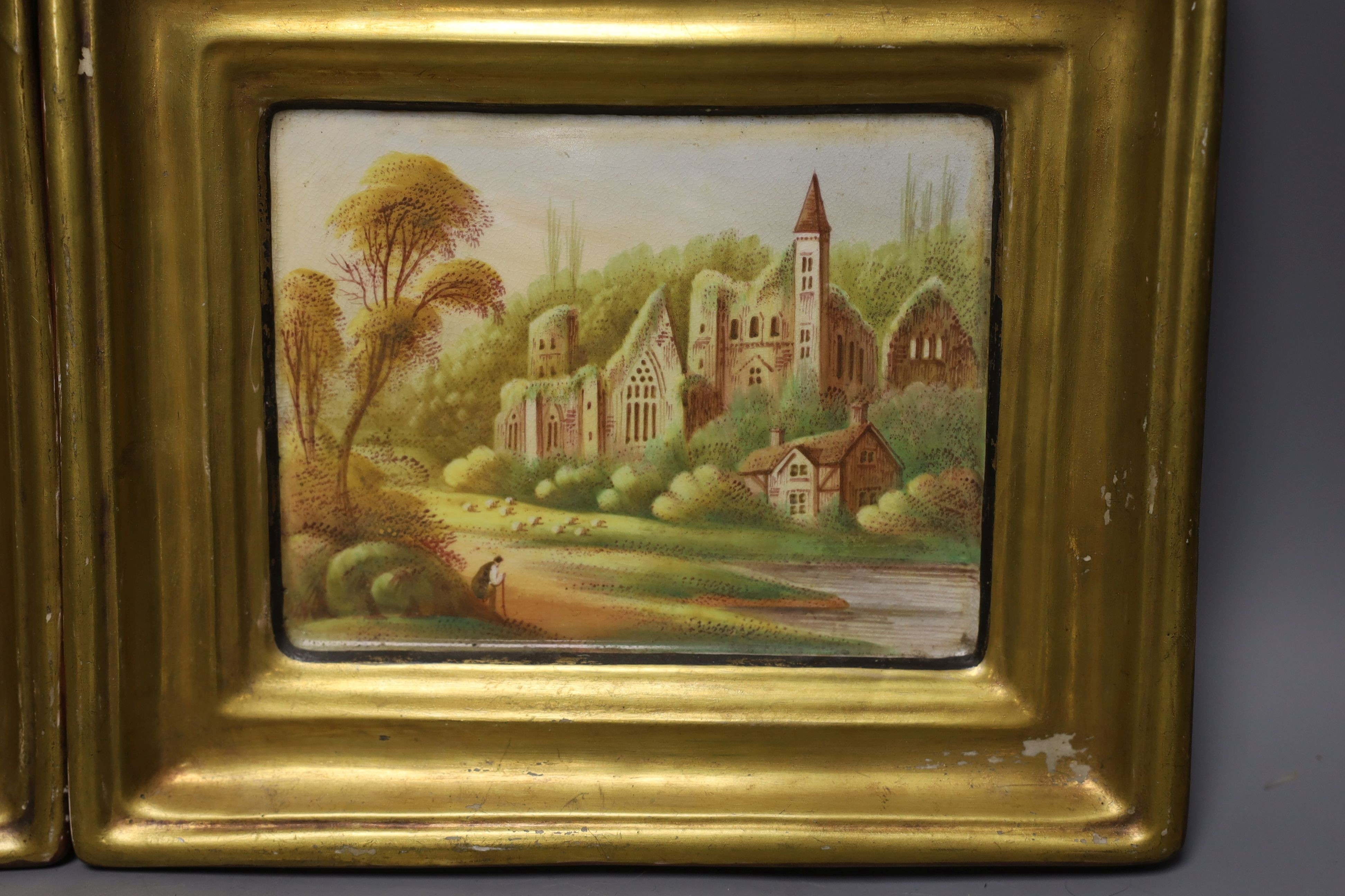 A pair of 19th century painted pottery hanging wall plaques depicting village scenes - 17 x 20cm